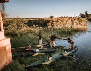 Polers docking their traditional canoes