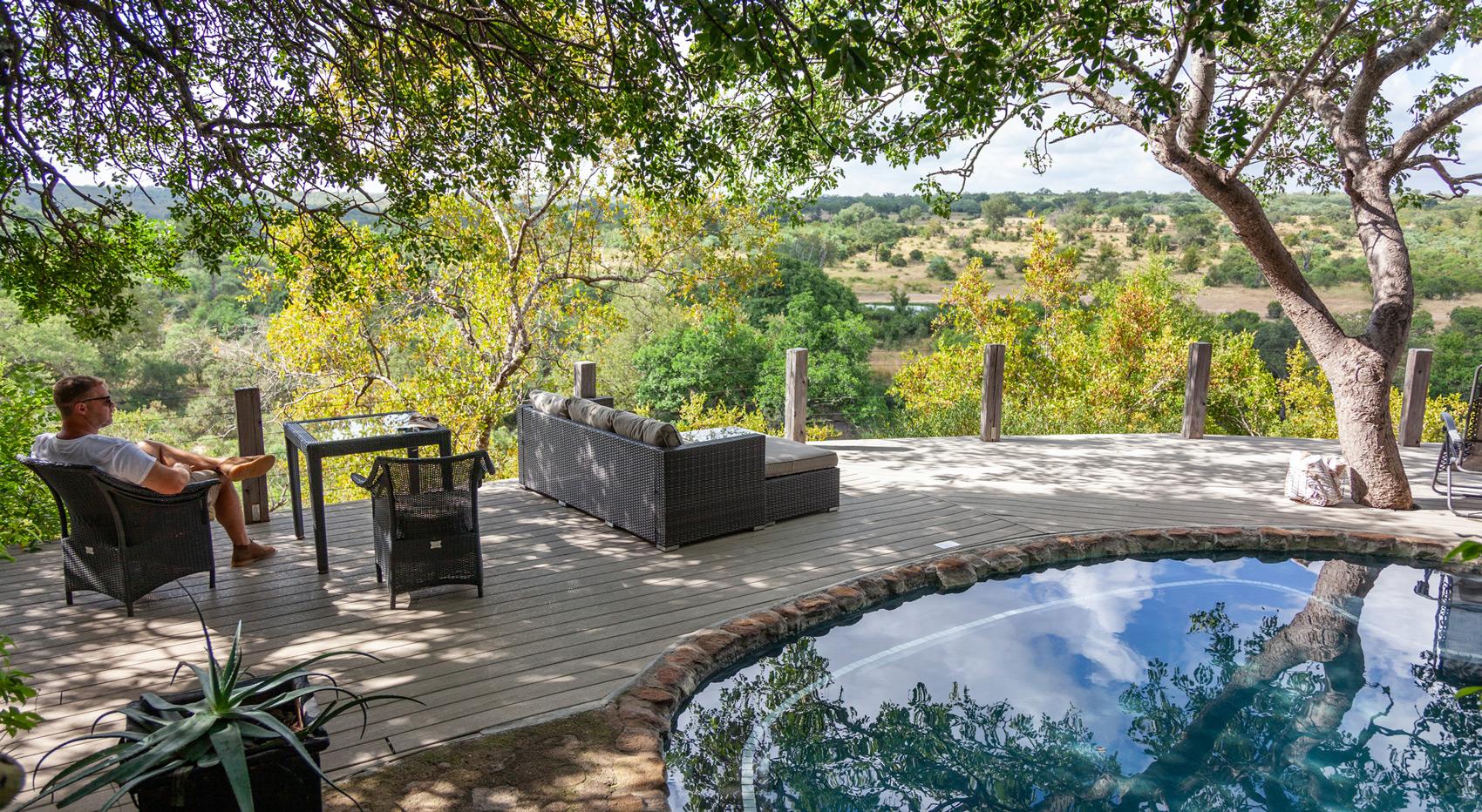 A guest relaxing by the pool in the Leopard Hills lodge in greater Kruger.