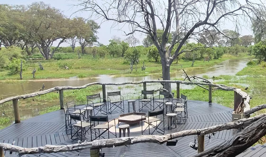 A viewing platform with a fire pit overlooks Botswana's wilderness, offering a perfect place to create unforgettable memories.